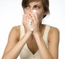 young woman with runny nose and tissue
