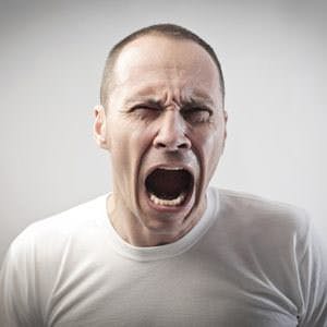 man screaming in pain or anger