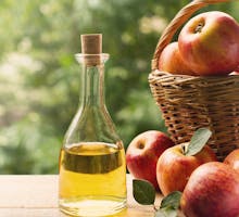 Apple cider vinegar in bottle with apple summer day
