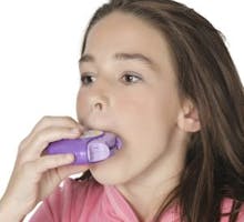 a girl using an asthma inhaler disk