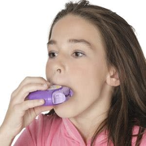 a girl using an asthma inhaler disk