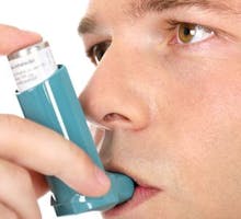 man using an asthma inhaler