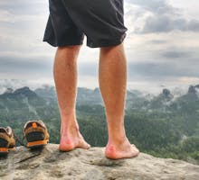 Barefoot hiker with blisters on his heels.