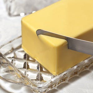 Butter in crystal butter dish with knife.
