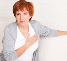 Mature woman holds her heart