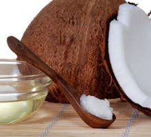 a coconut and coconut oil on a spoon