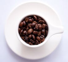 roasted coffee beans in an espresso cup can help reduce your risk for COVID