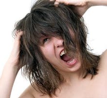 woman yelling with her fingers in her hair, itchy scalp