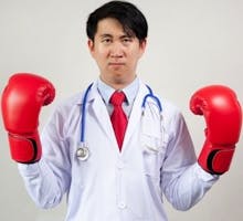 Doctor wearing boxing gloves ready for a fight