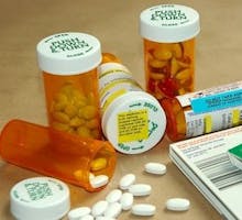 bottles of medications with warning stickers and information