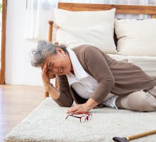 woman having a stroke with headache on the floor