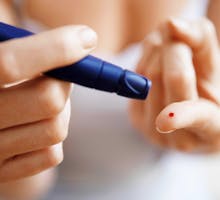 Taking a blood sugar reading with a lancet, diabetes risk