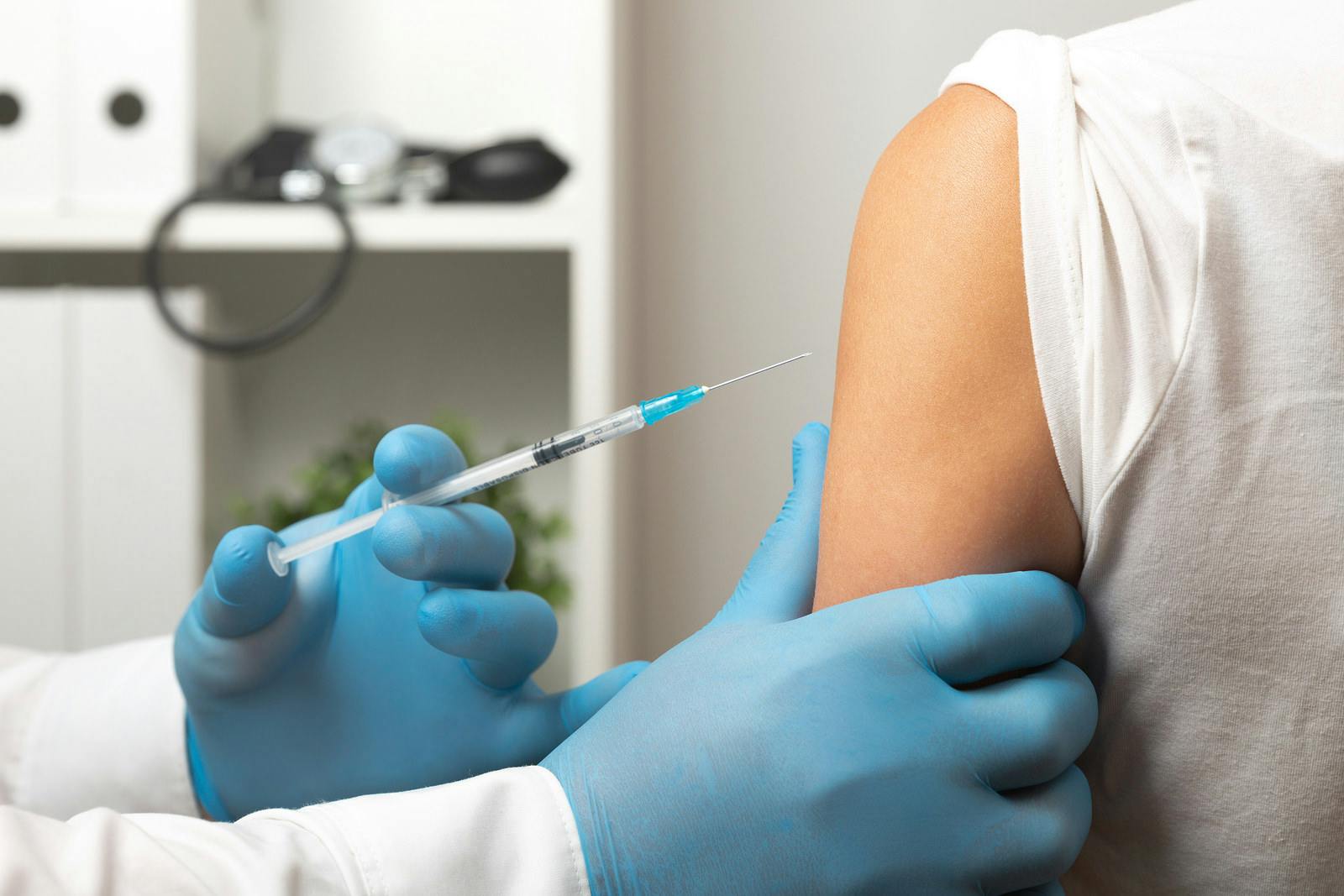 Doctor prepares to give a flu shot or COVID-19 vaccine