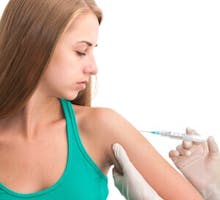 Young woman getting a flu vaccine injection