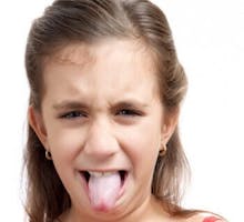 a little girl sticking out her tongue in disgust.