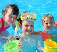 happy children swimming in summertime