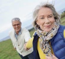 Older woman leads man on walk for light physical activity