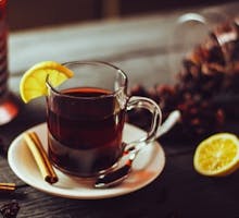 Cup of hibiscus tea with lemon and cinnamon