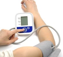 Female hands with blood-pressure meter