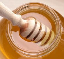 honey dipper in a jar of honey
