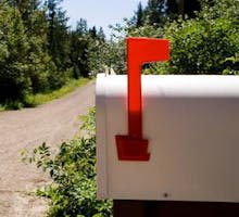 a mailbox on a country road on a sunny day