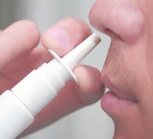 Man uses a nasal spray for treatment