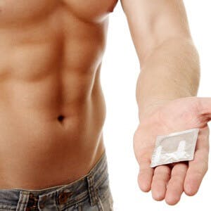 bare chested man with muscles holds out testosterone patch