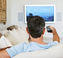 man with remote watching TV