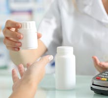 pharmacist hands selling medicines to a customer on a pharmacy desk; simple job description