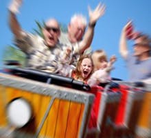 Father and Daughter On Amusement Park Roller Coaster