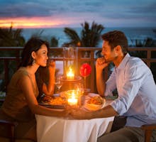 couple having romantic late dinner by candlelight
