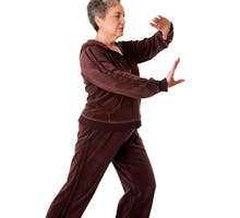 Older woman practicing tai chi to improve her balance