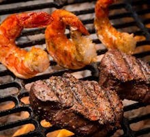 shrimp and steak on a grill