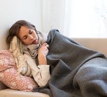 Woman lying on sofa with the flu during a bad flu season