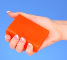 woman holding a bar of soap to get rid of hand cramps