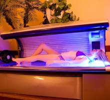 Woman using indoor tanning bed