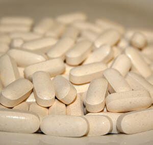a large pile of vitamin pills, calcium supplements