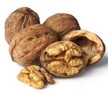 walnuts in their shells and a cracked walnut