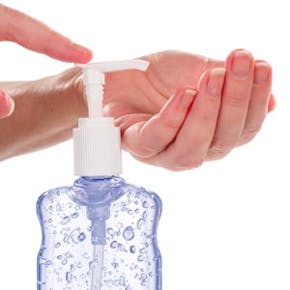 Woman Pumping Gel Hand Sanitizer From A Bottle