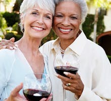 Senior women drinking wine together
