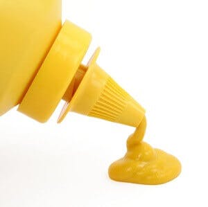 A bottle of yellow mustard with white background
