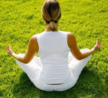 woman sitting in cross-legged yoga pose, yoga practice