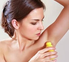 woman applying a roll on antiperspirant or deodorant