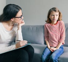 Psychologist evaluating young girl for autism spectrum disorder