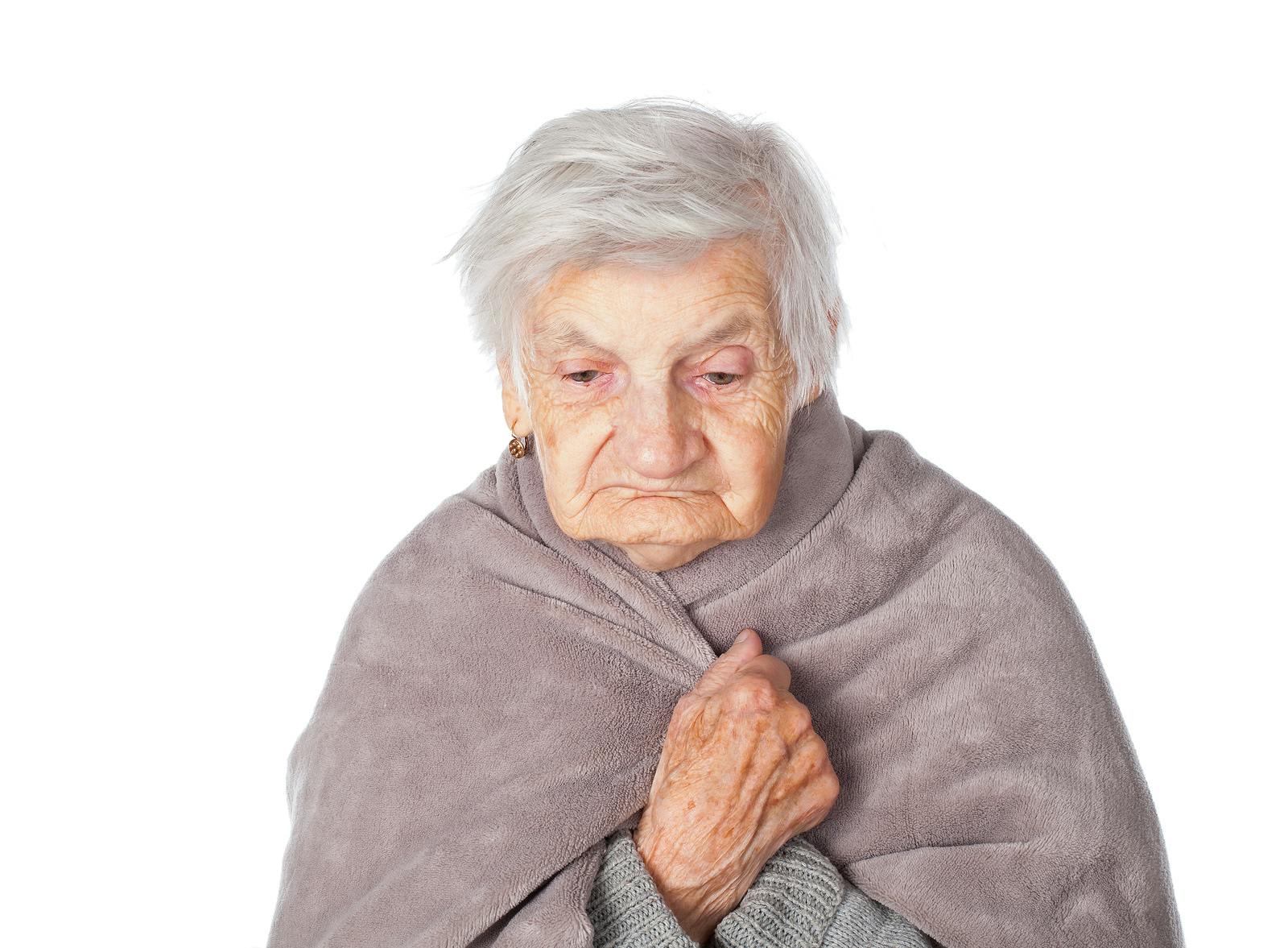 elderly woman wrapped in gray blanket due to respiratory infection, dementia genes