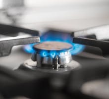 Lit gas burner on a kitchen stove