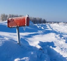 a winter frozen mail box under snow