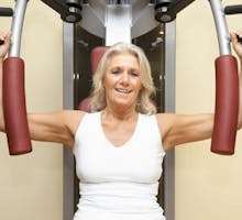older woman exercising at the gym