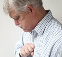 older man with heartburn, acid reflux or indigestion