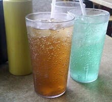 glasses of soft drinks and sodas, sugary drinks